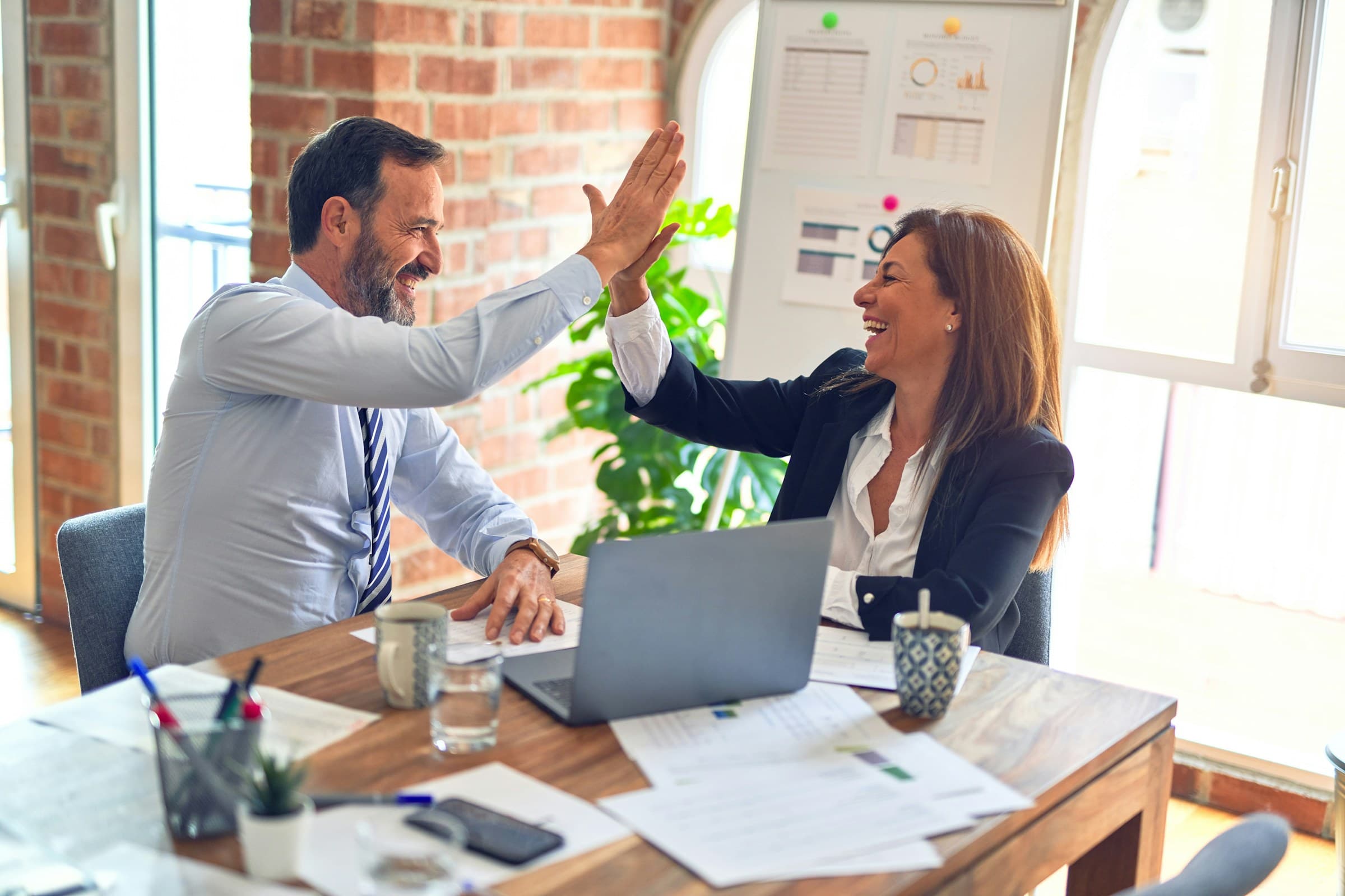 A SMAART tax advisor celebrating a successful outcome with a client